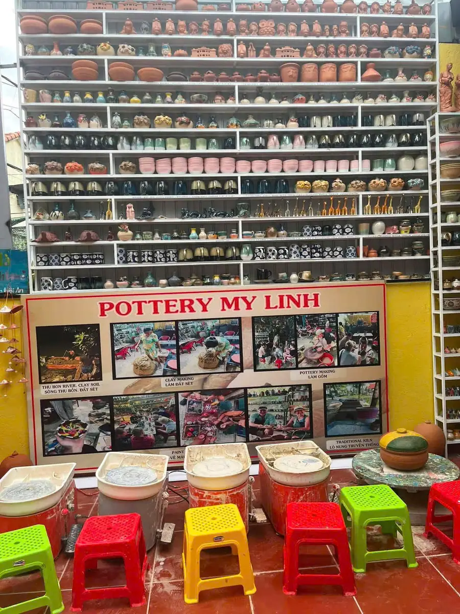 Spacious My Linh pottery workshop space with sturdy roofing and rows of handmade glazed pottery
