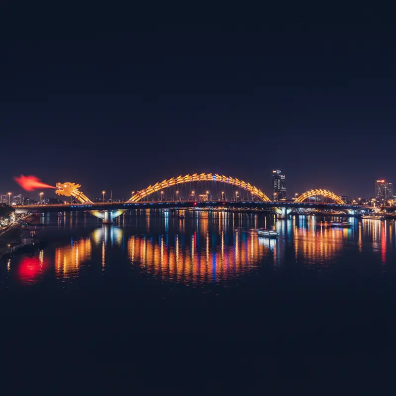 Full view of Dragon Bridge Da Nang at night with a brilliant LED light system reflecting down on the Han River, photographed from the west bank looking across, showcasing the beautiful symbol of the fire-breathing dragon bridge