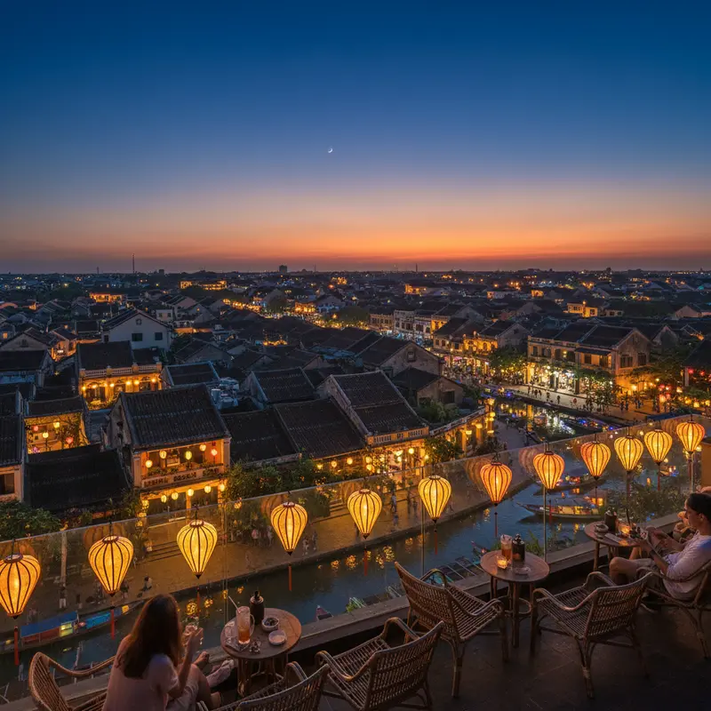 Hoi An cafe rooftop overlooking the ancient town with mossy tiled roofs, illuminated lanterns at night, and magical warm orange light